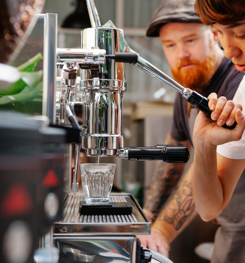 Technician repairing commercial espresso machine in Dubai