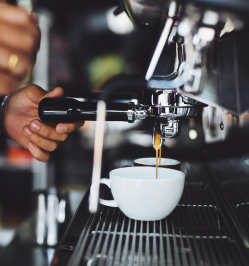 Technician calibrating coffee grinder in Dubai cafe