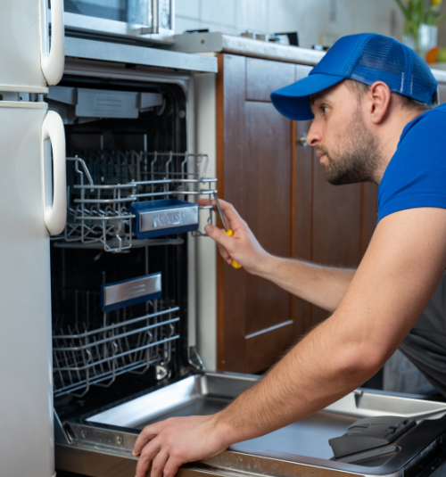 Technician repairing commercial dishwasher in Dubai