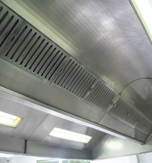 Technician performing ventilation system maintenance