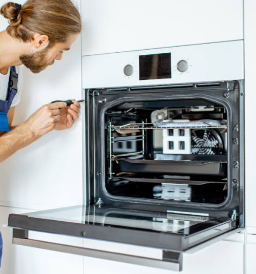 Commercial oven technician making repair