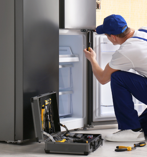 Commercial refrigerator technician repairing unit in Dubai