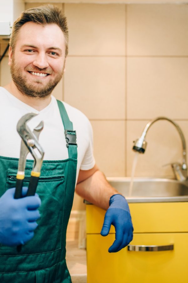 plumber-in-uniform-holds-wrench-handyman.jpg